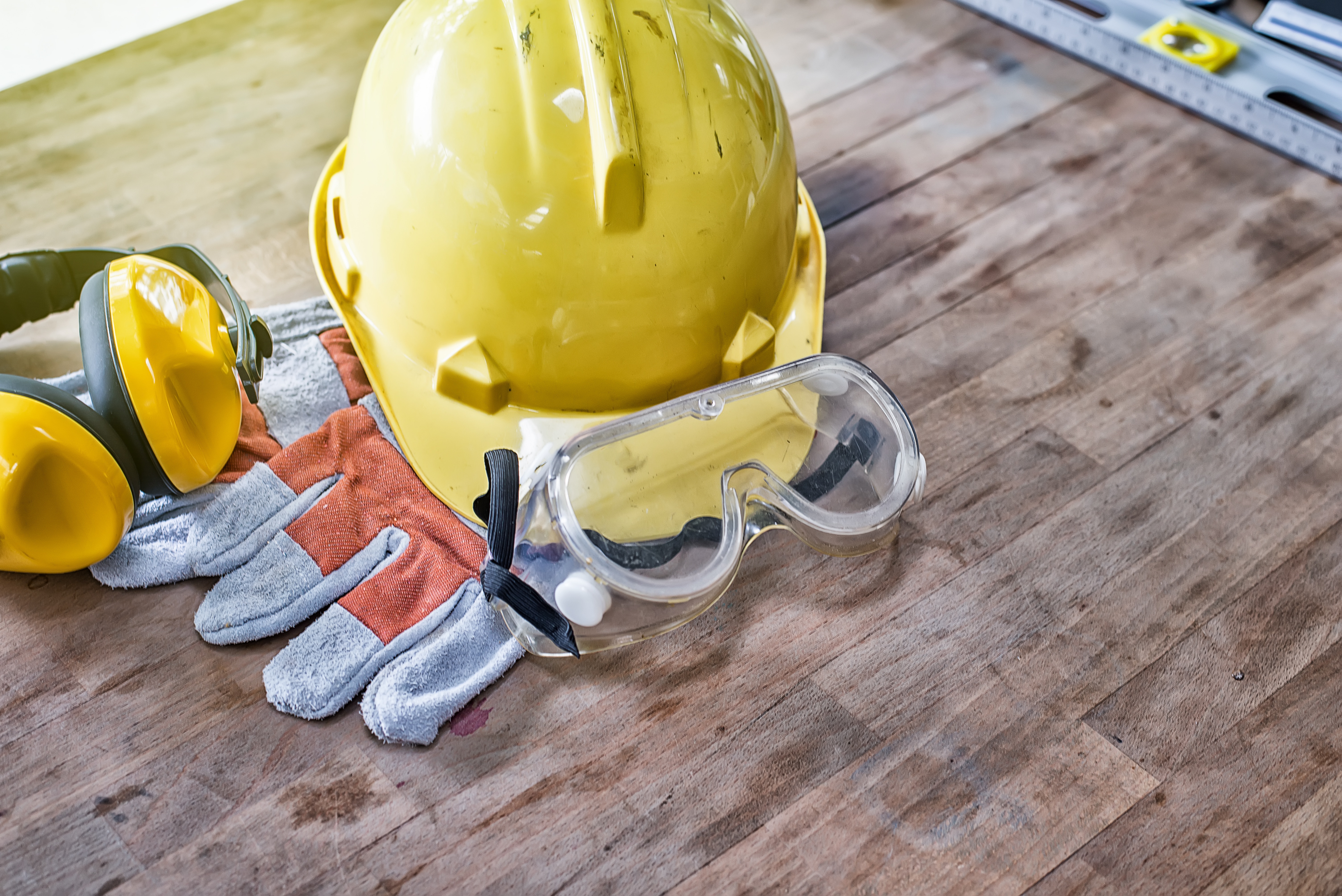 Standard construction safety equipment on wooden table. top view