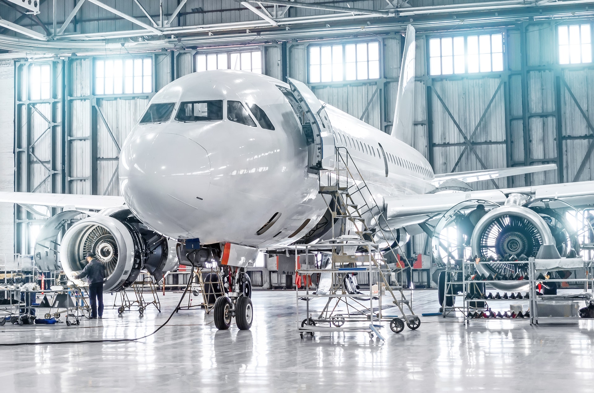 Passenger,Aircraft,On,Maintenance,Of,Engine,And,Fuselage,Repair,In Passenger aircraft on maintenance of engine and fuselage repair in airport hangar